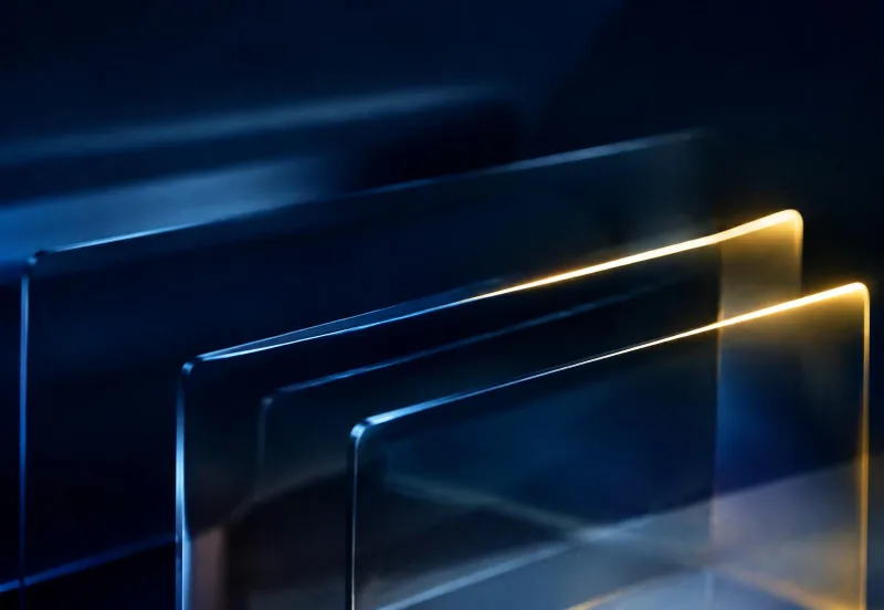 Layered glass panels in deep navy with a gold light edge